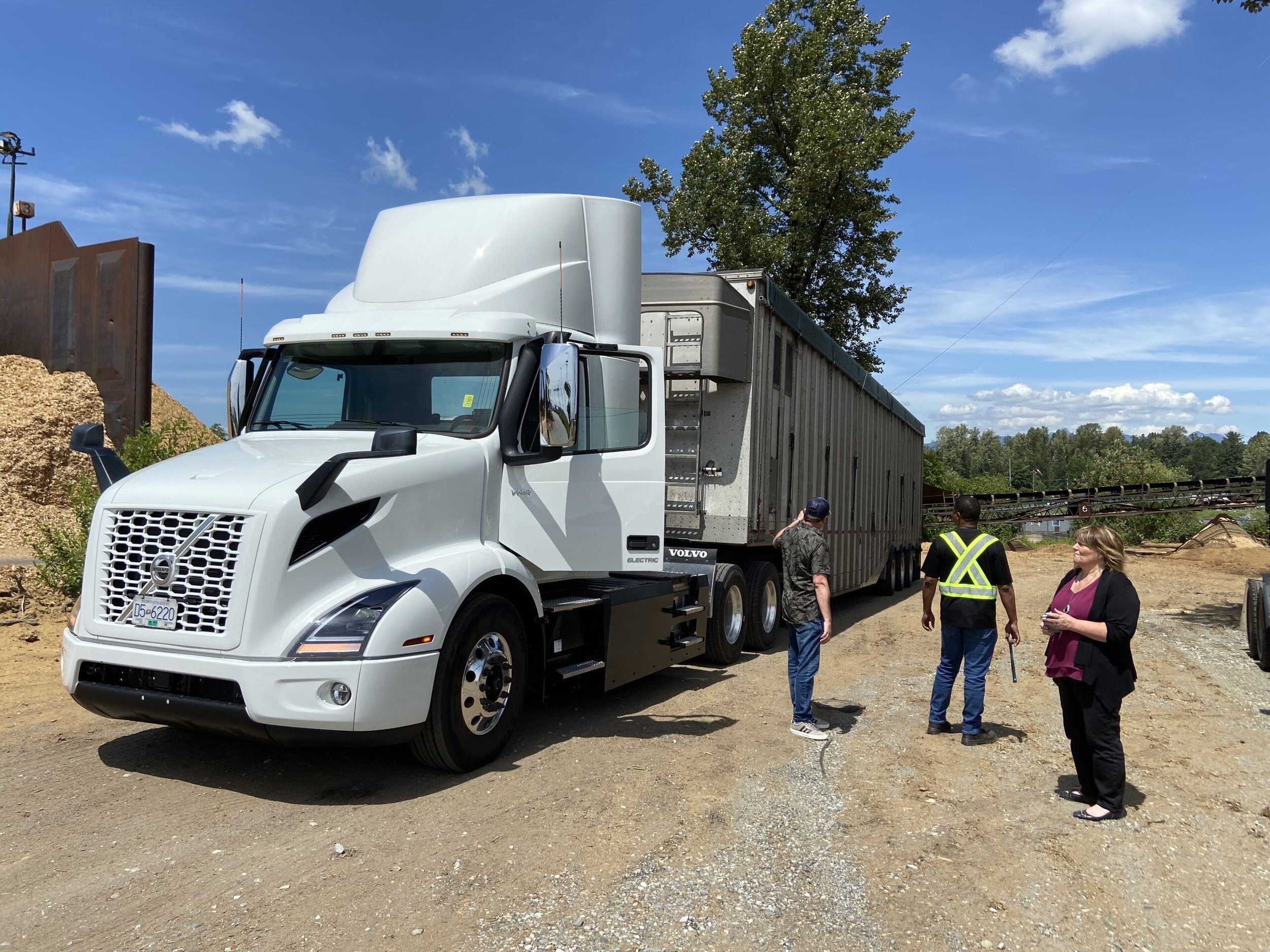 ZETT Truck on a sunny day with three employees wearing safety vests ZETT Truck on a sunny day with three employees wearing safety vests