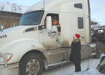 Handing out a turkey to a truck driver for the Turkey for Truckers program